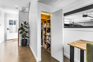 Bardon Brisbane home renovation – entryway with hidden linen storage and polished concrete floors.
