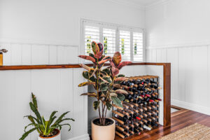Queenslander renovation Bardon Brisbane – feature wine storage with timber flooring and plantation shutters.