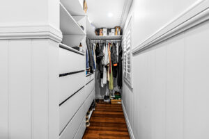 Bardon Brisbane home renovation – modern walk-in wardrobe with built-in shelving and timber floors.